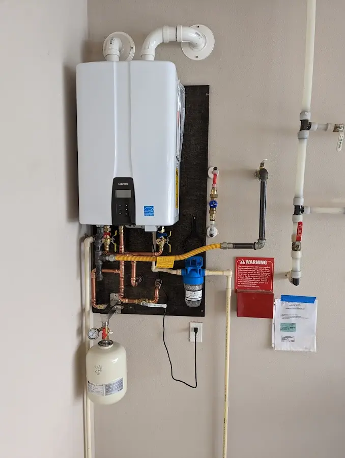 Professional plumber installing copper piping in a West Tisbury home